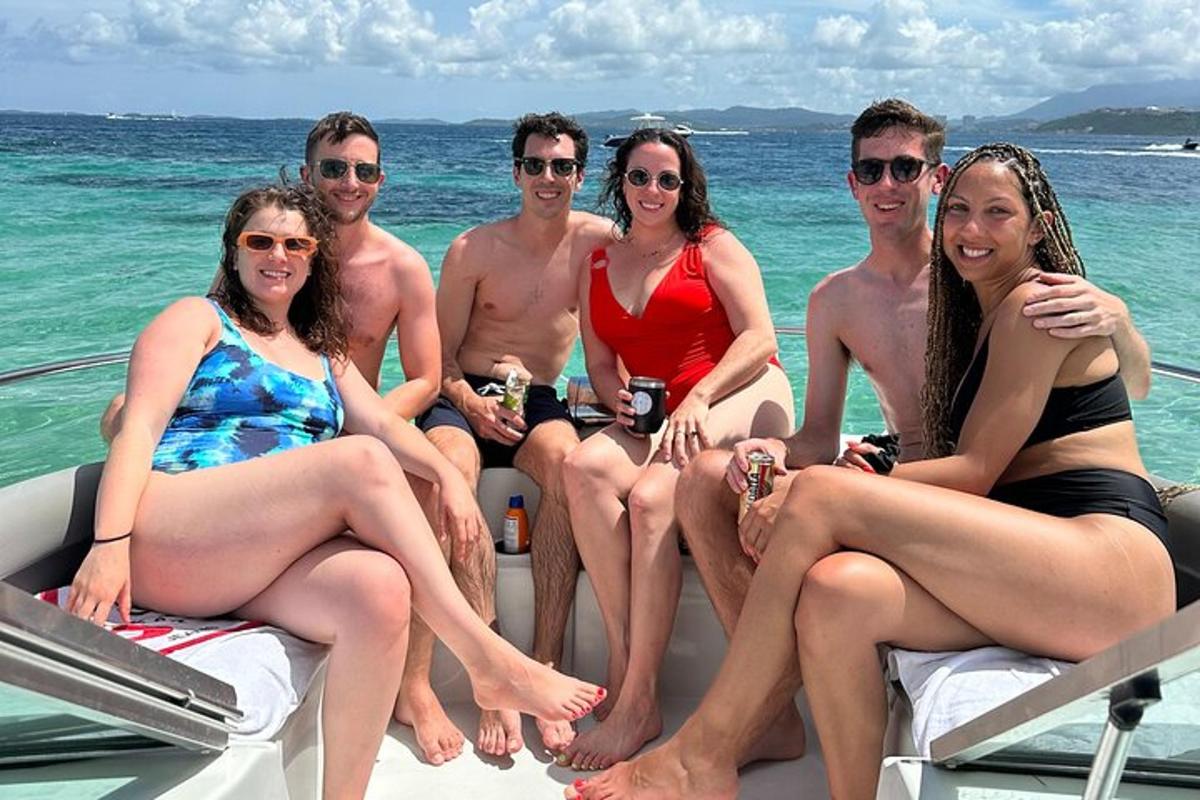 a group of people sitting on a boat in the water