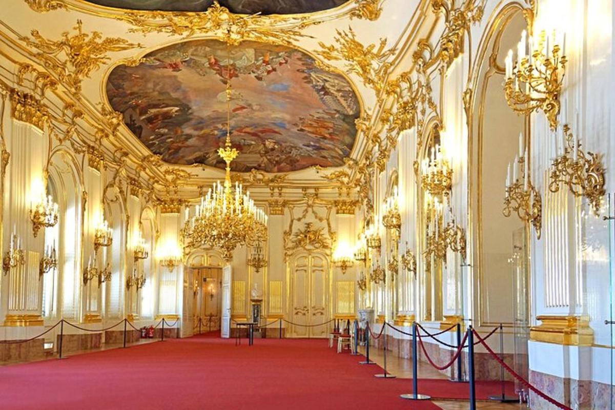 a large room with a red carpet and a painting on the ceiling