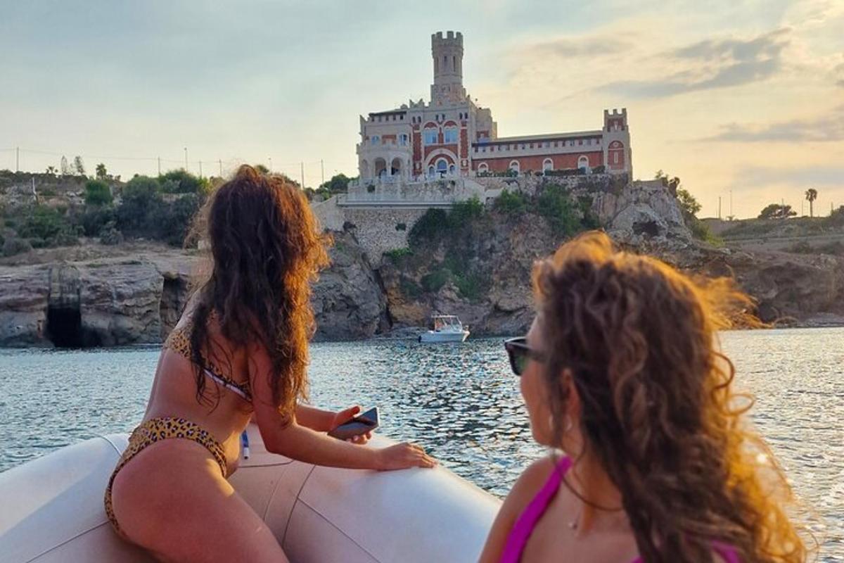 due donne su una zattera in acqua con un castello sullo sfondo