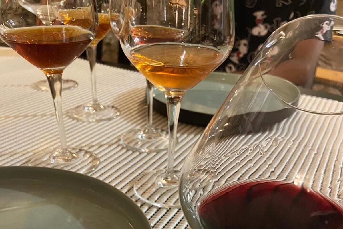 three wine glasses sitting on top of a table