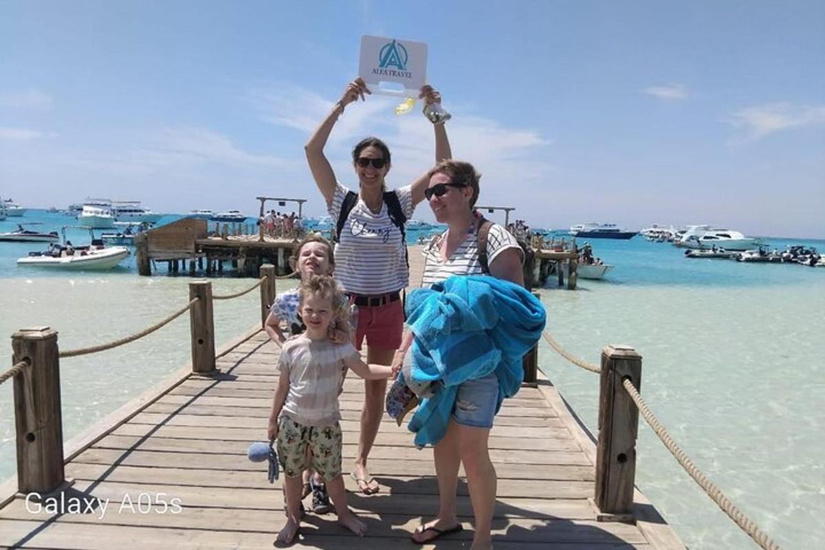 two women and a child on a dock with a sign