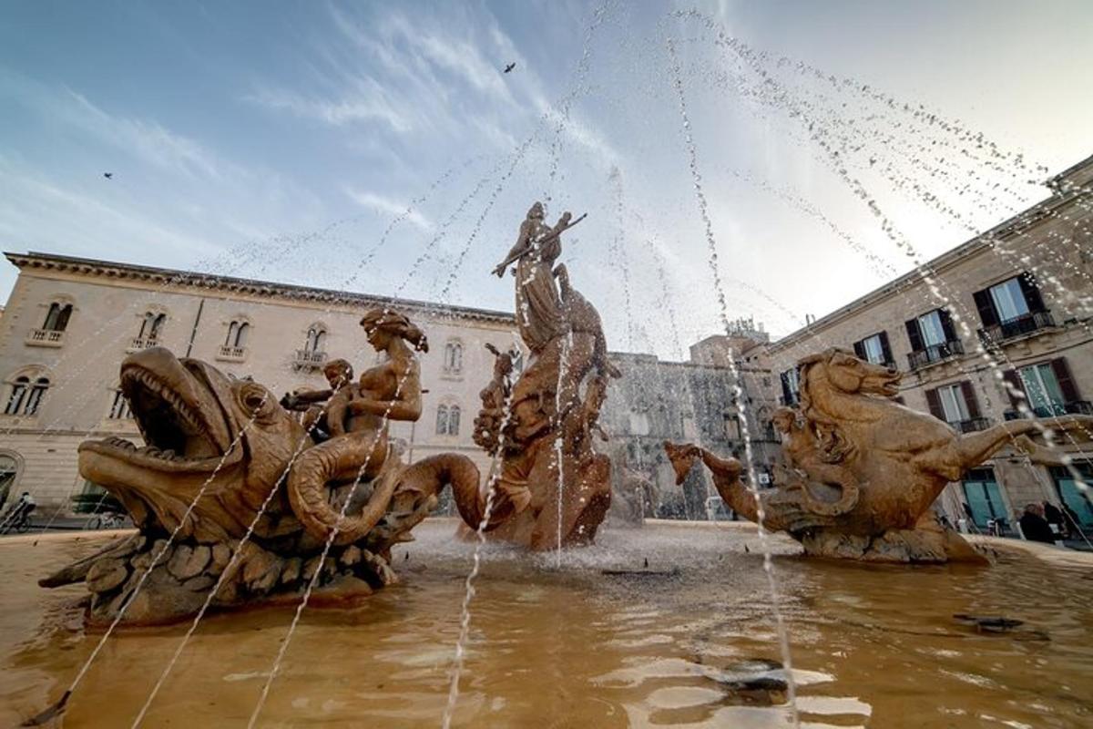 a fountain in front of a building with water