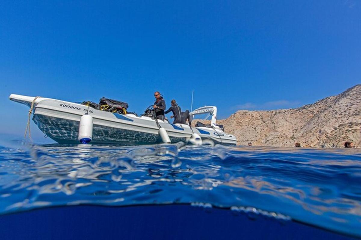 two people sitting on a boat in the water