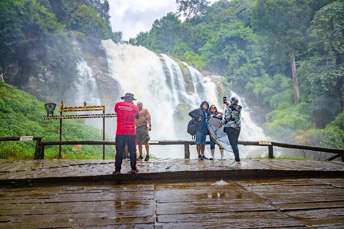 un gruppo di persone in piedi davanti a una cascata
