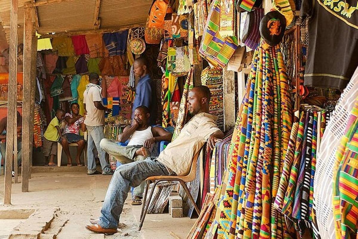 un uomo seduto su una sedia in un mercato