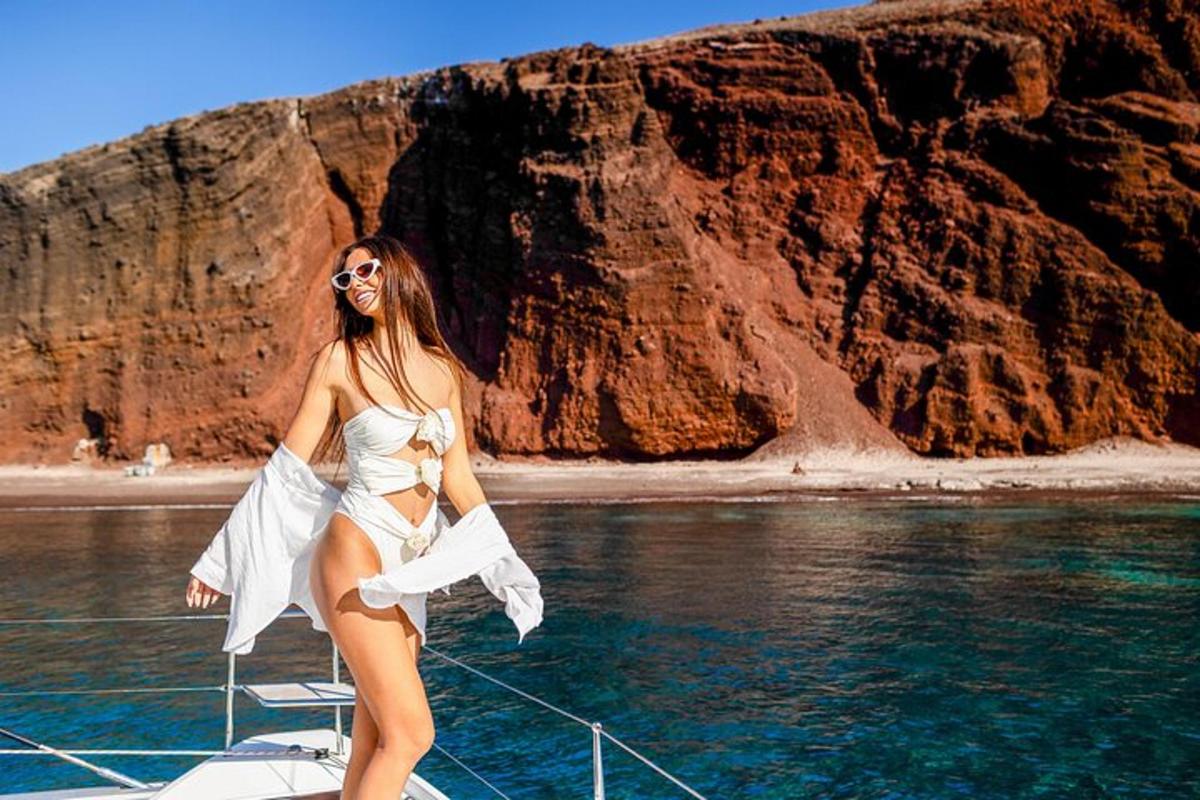 a woman is standing on a boat in the water