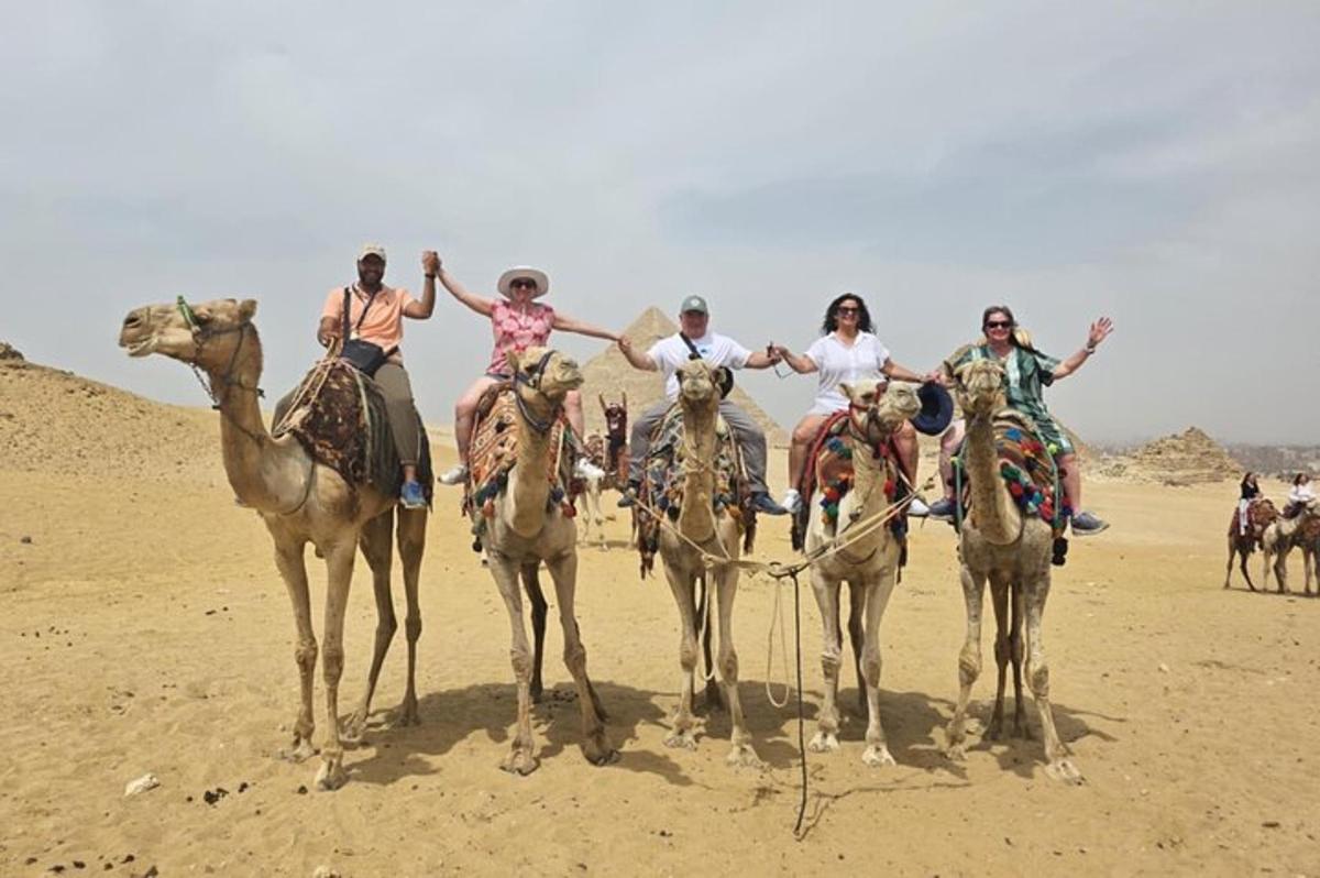 a group of people riding on camels in the desert