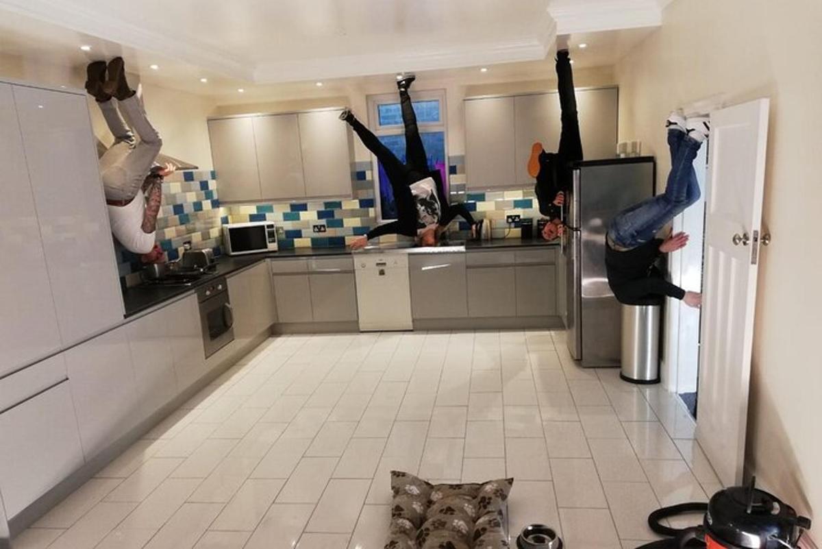 two people jumping in a kitchen with their legs in the air