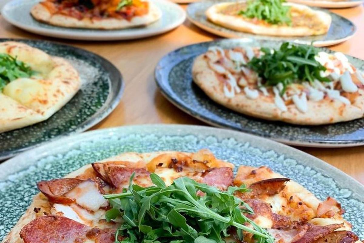 a group of pizzas on plates on a table