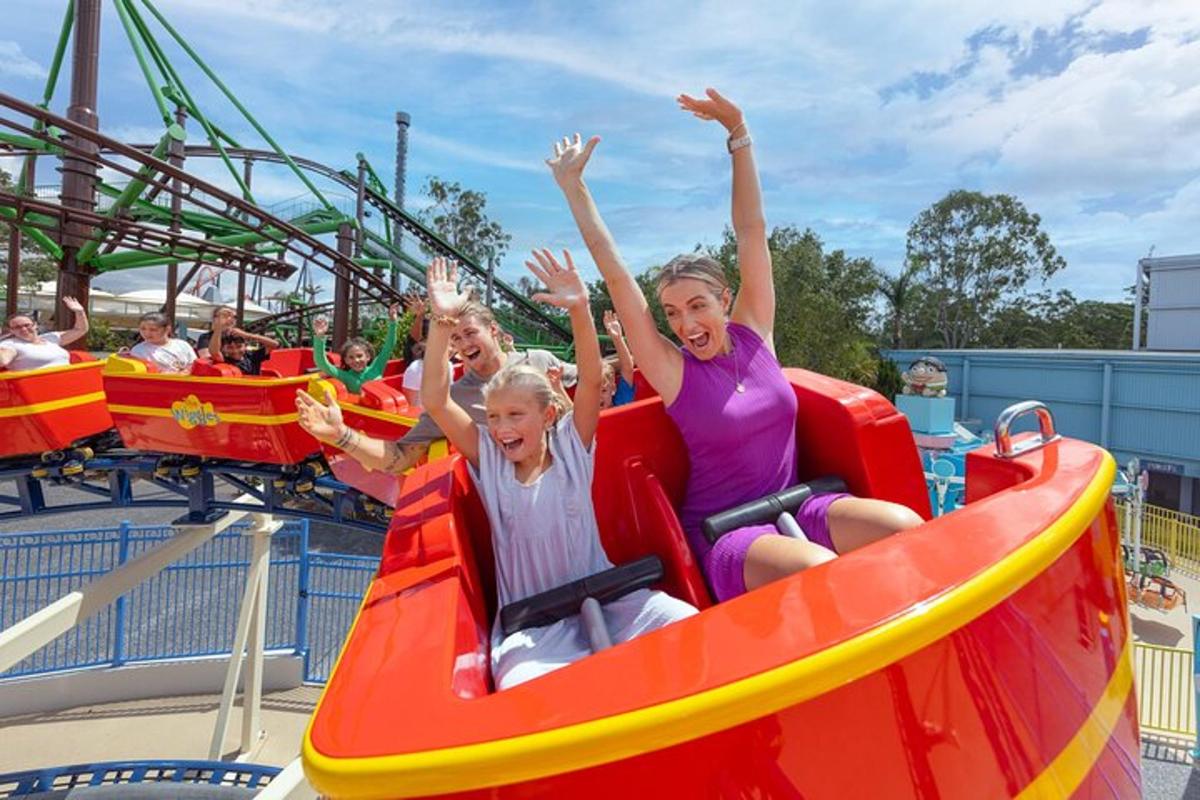 two women riding on a roller coaster at a theme park