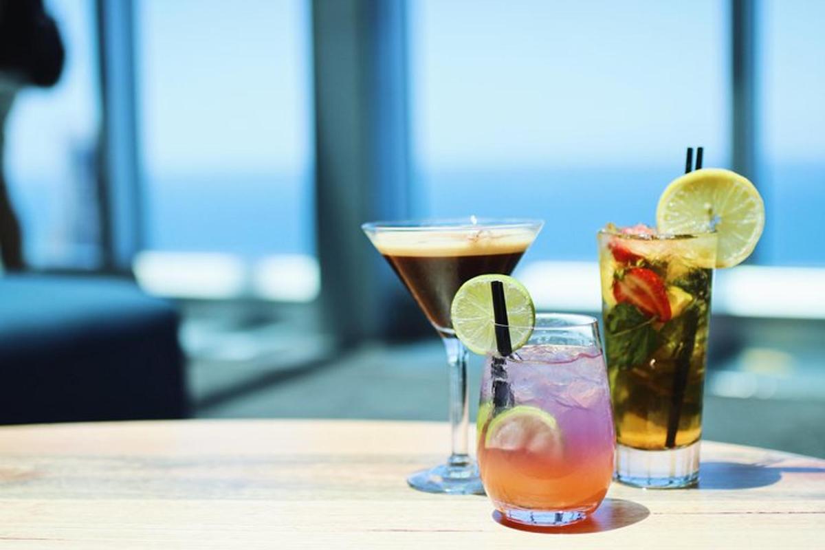 three cocktails sitting on a wooden table