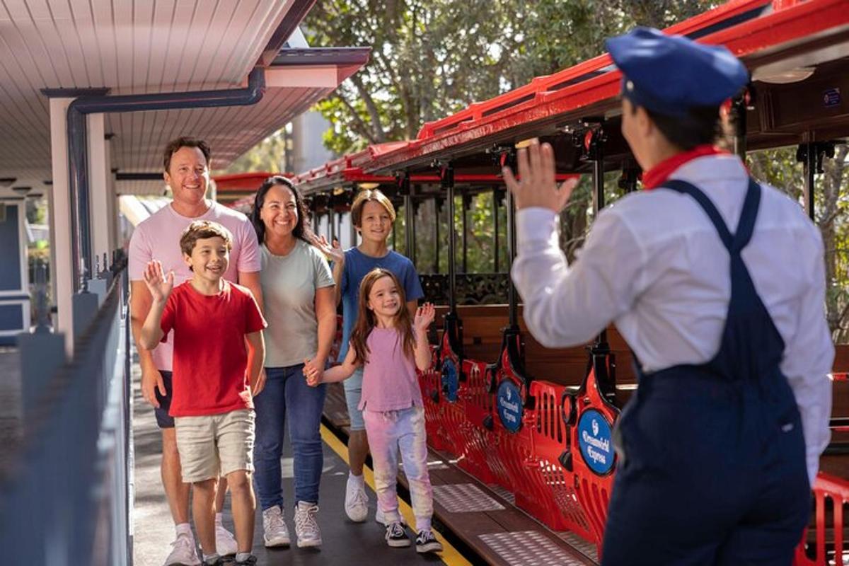 a family posing for a picture in front of a train