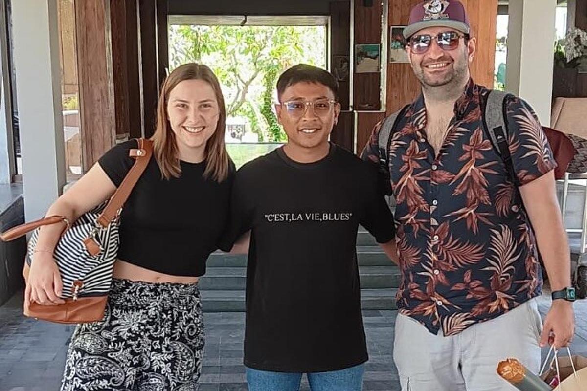 a woman and two men posing for a picture