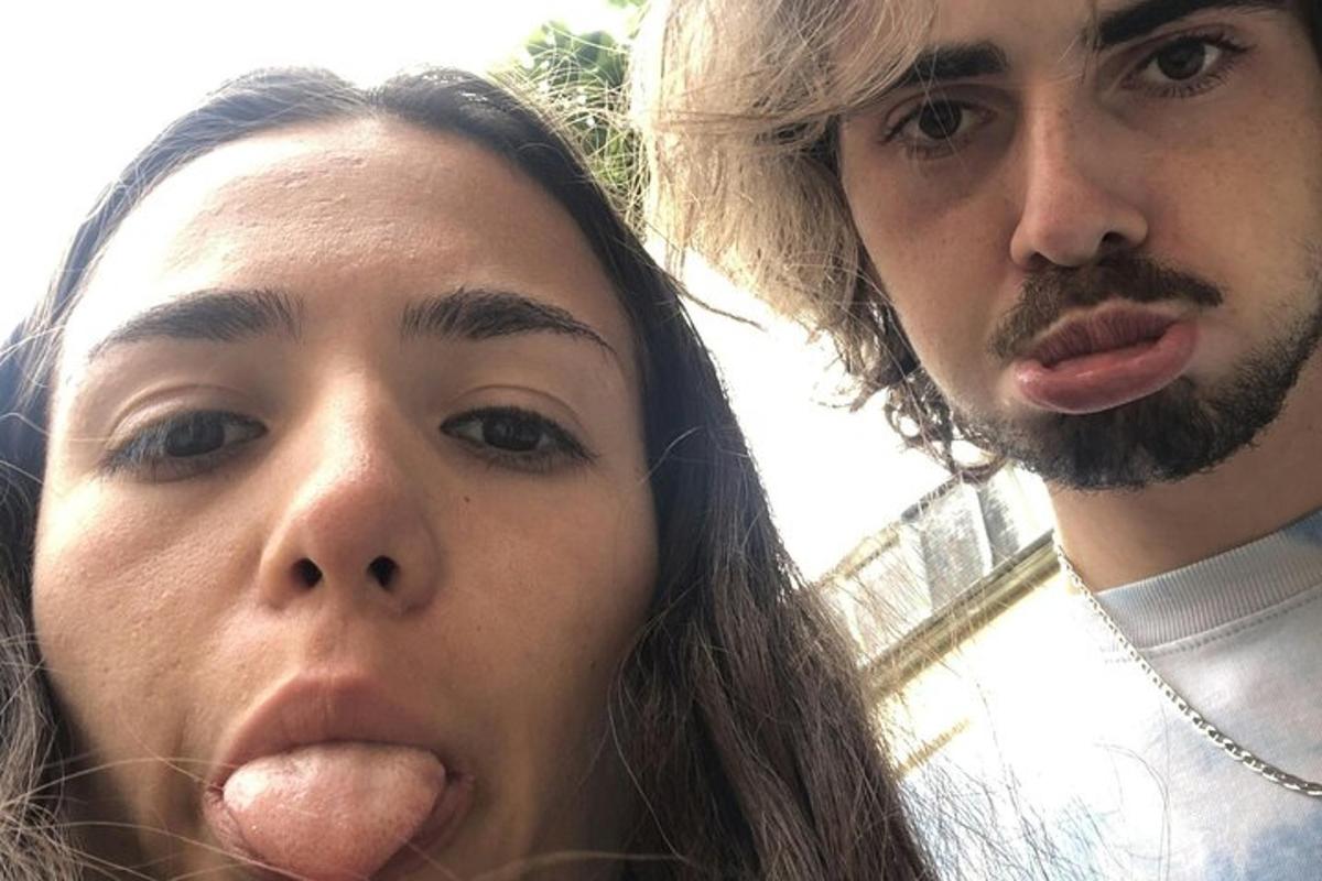 a man and a woman sticking their tongue