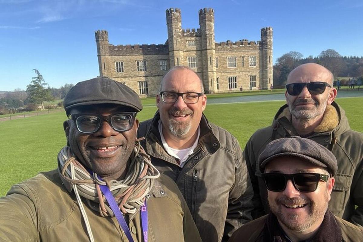a group of men standing in front of a castle