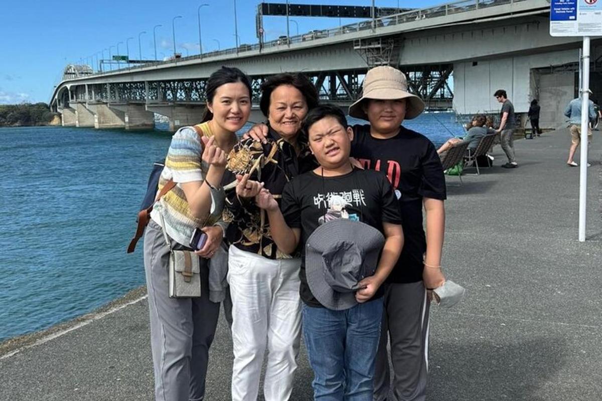 a group of people standing next to the water