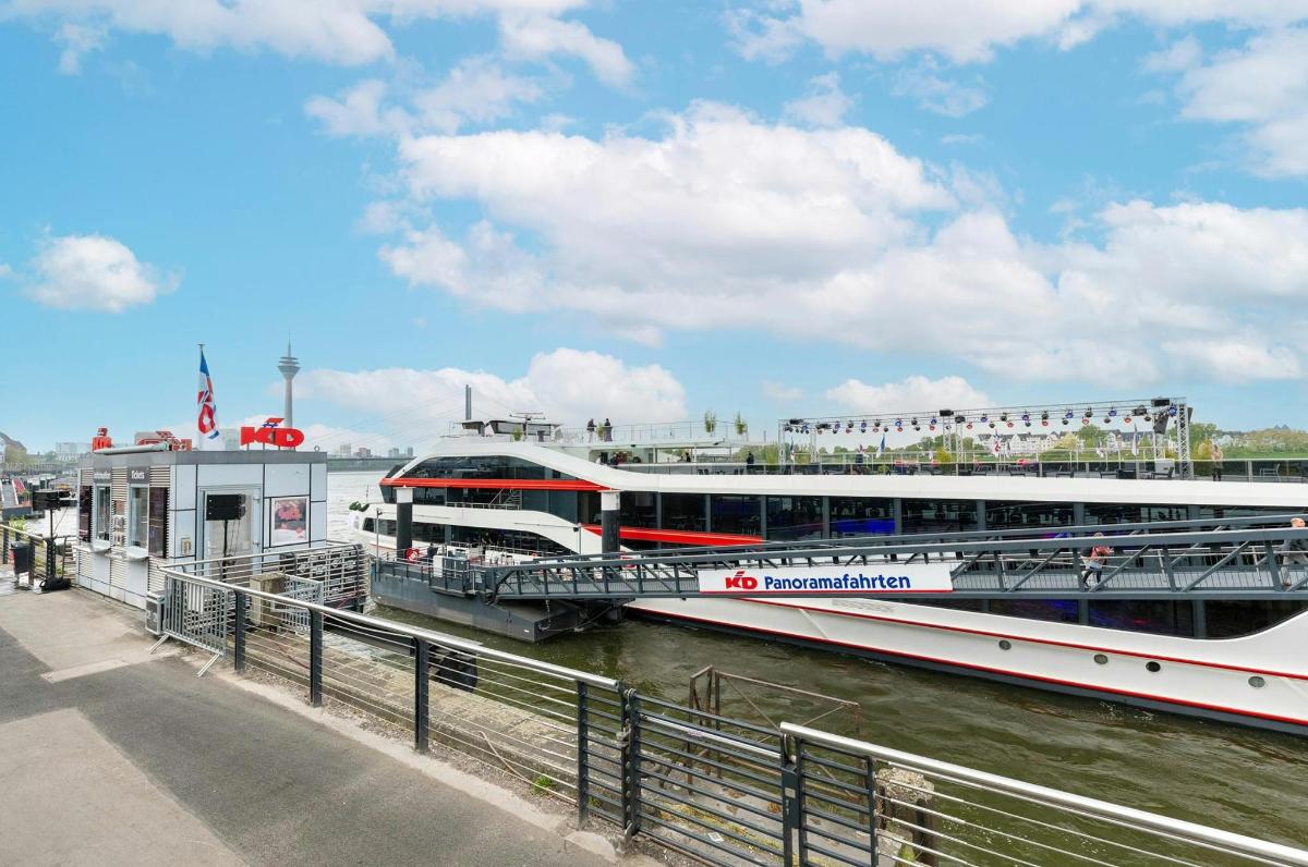a large boat is docked next to a river