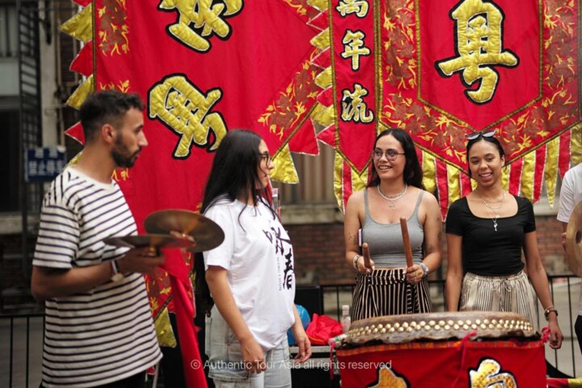 a group of people standing in front of a drum
