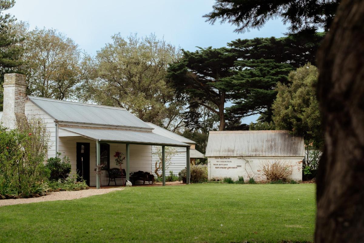 a white house with a porch and a yard