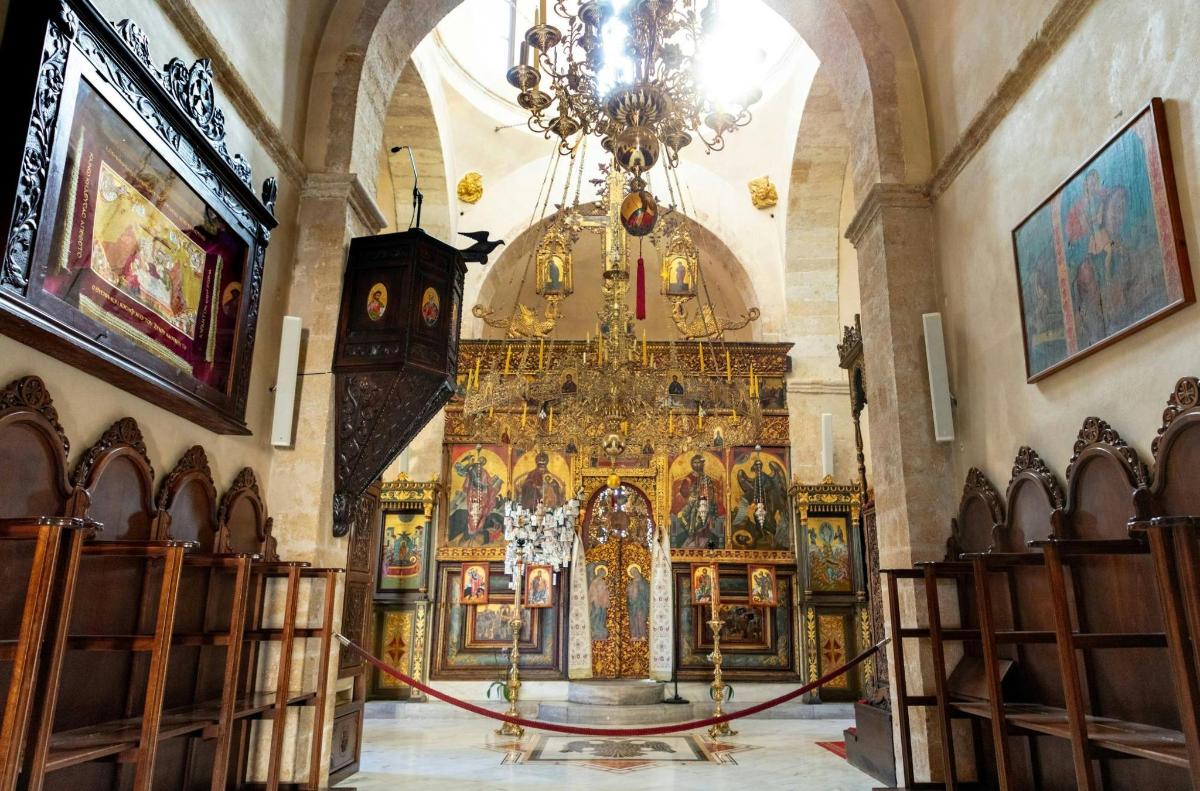 an altar in a church with a chandelier