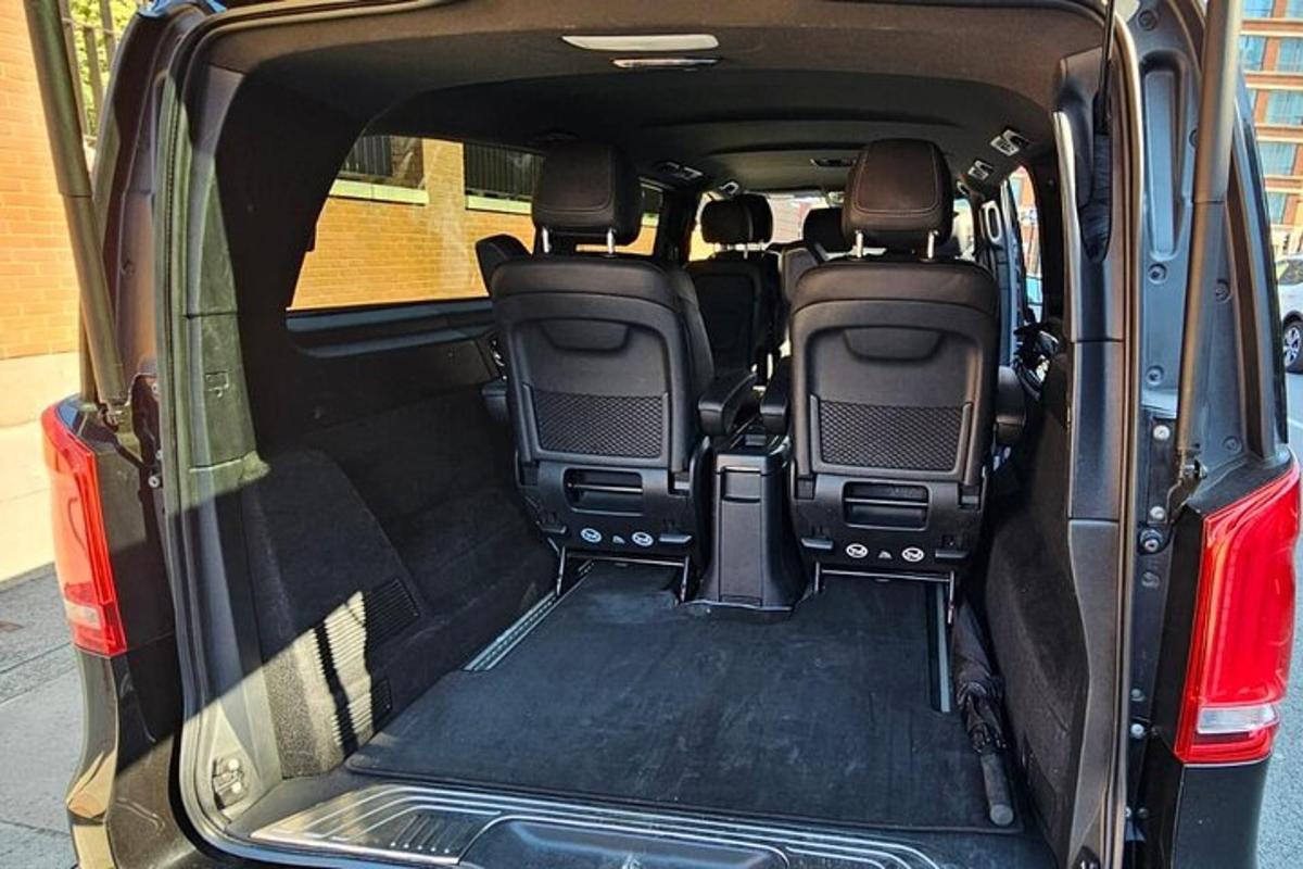an open trunk of a car with the back doors open
