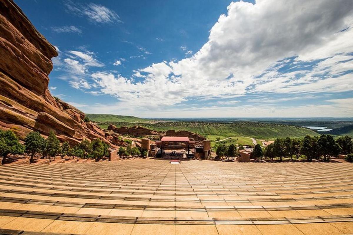 a large amphitheater with a building on top of a mountain