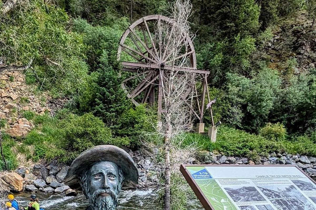 a statue of a man in the middle of a river