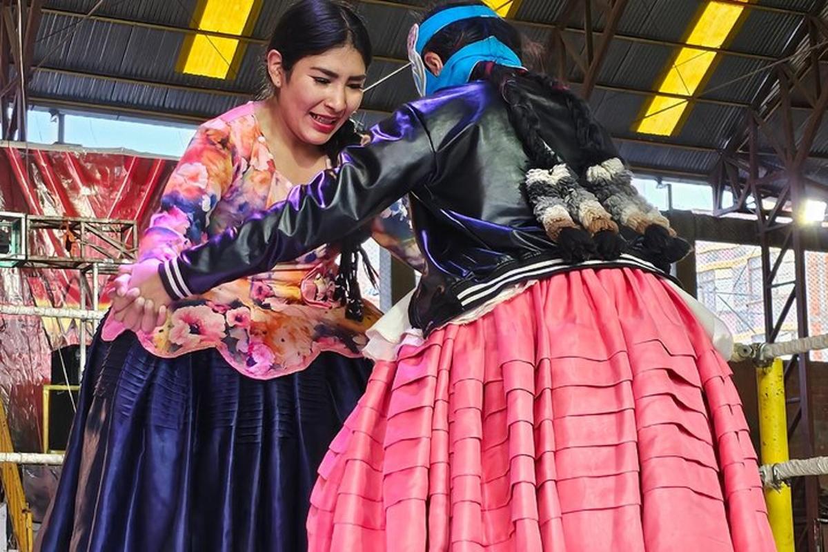 a woman standing next to a woman in a dress