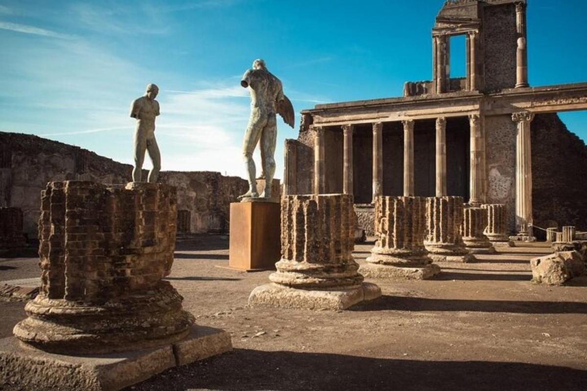 a statue of two men standing on columns in front of a building