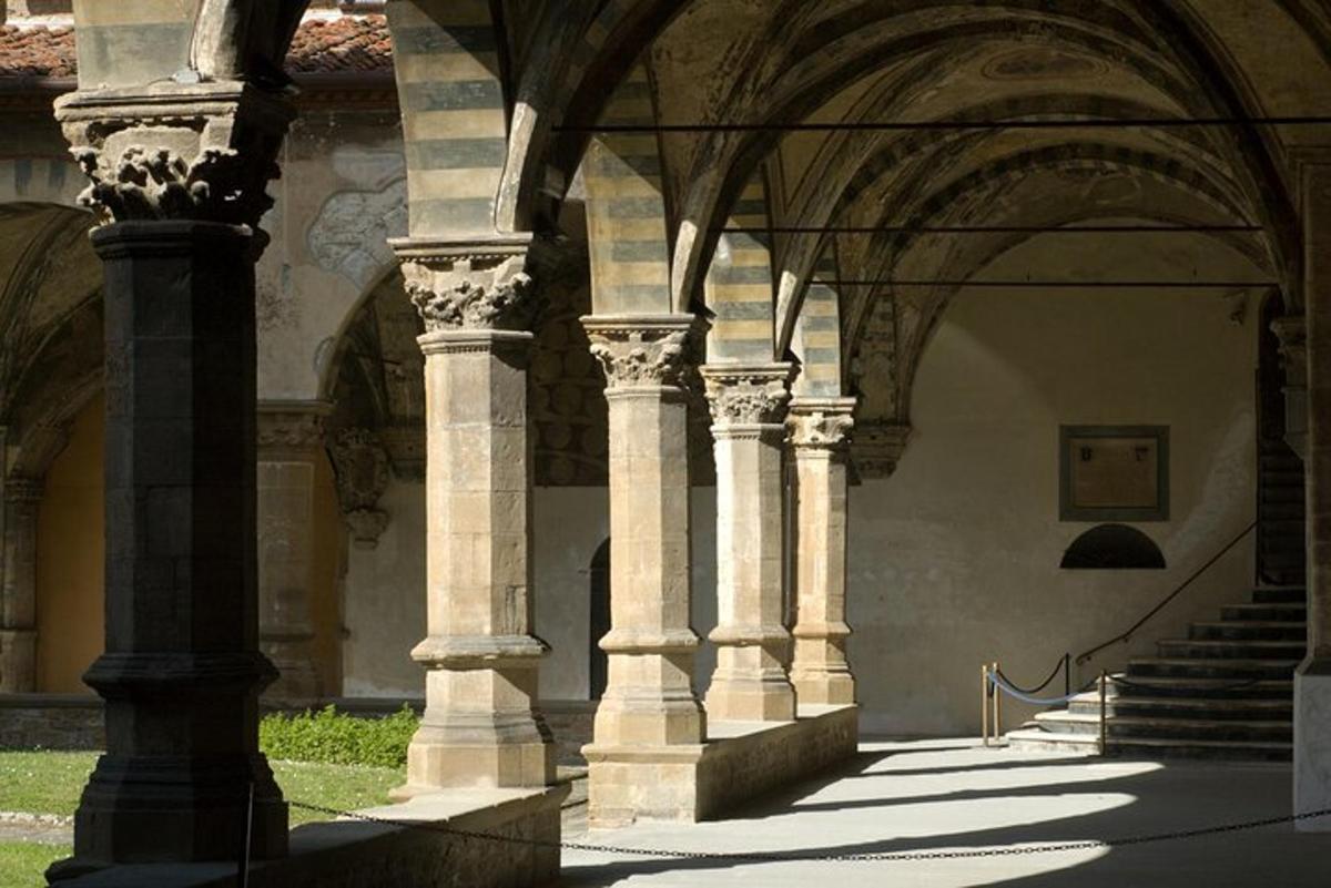 a building with columns and an archway with stairs