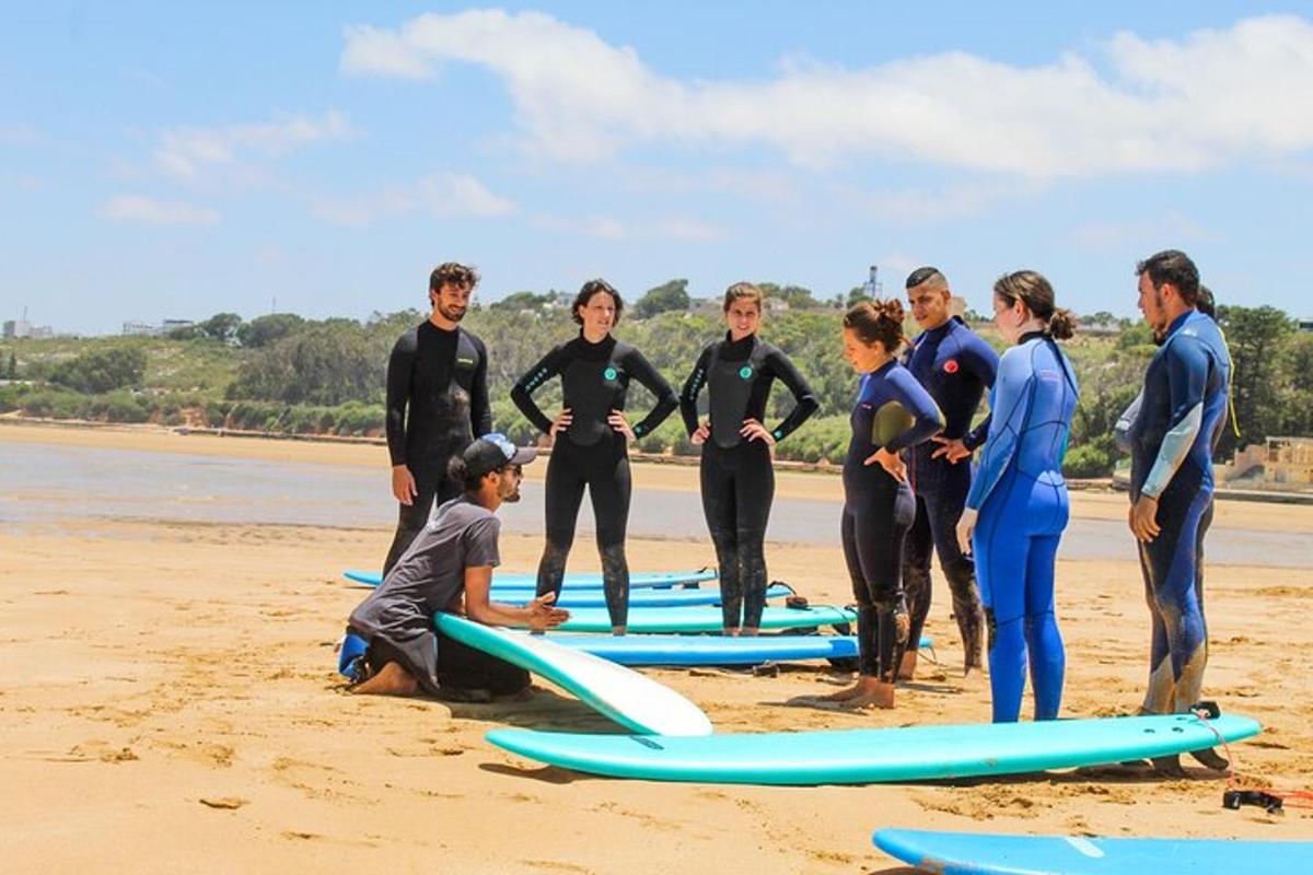 a group of people standing on a beach with surfboards