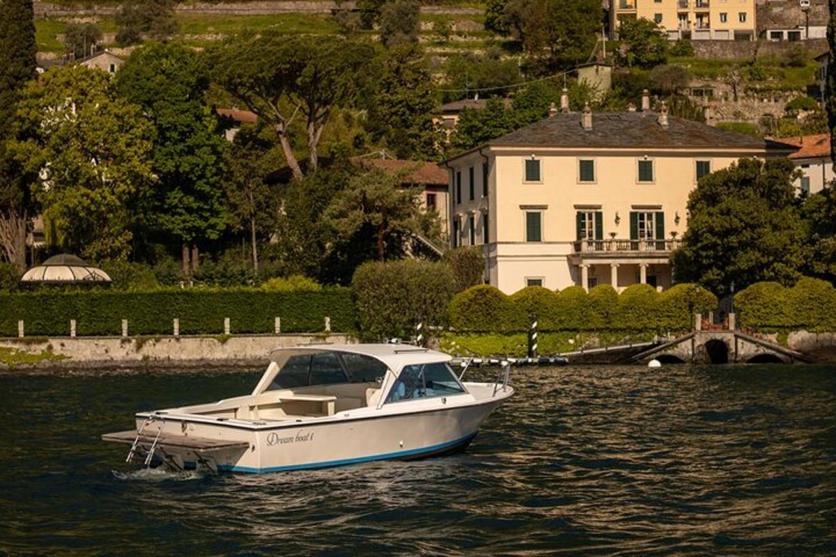un barco blanco en el agua frente a una casa