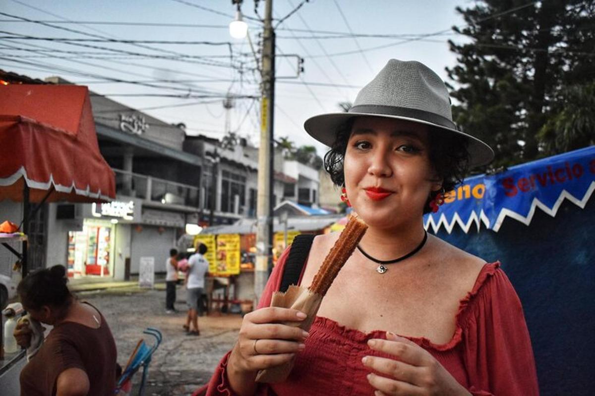 a woman wearing a hat and holding a popsicle