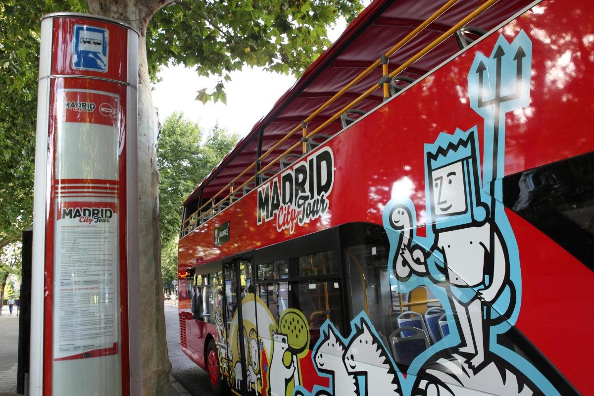 a red bus with graffiti on the side of it