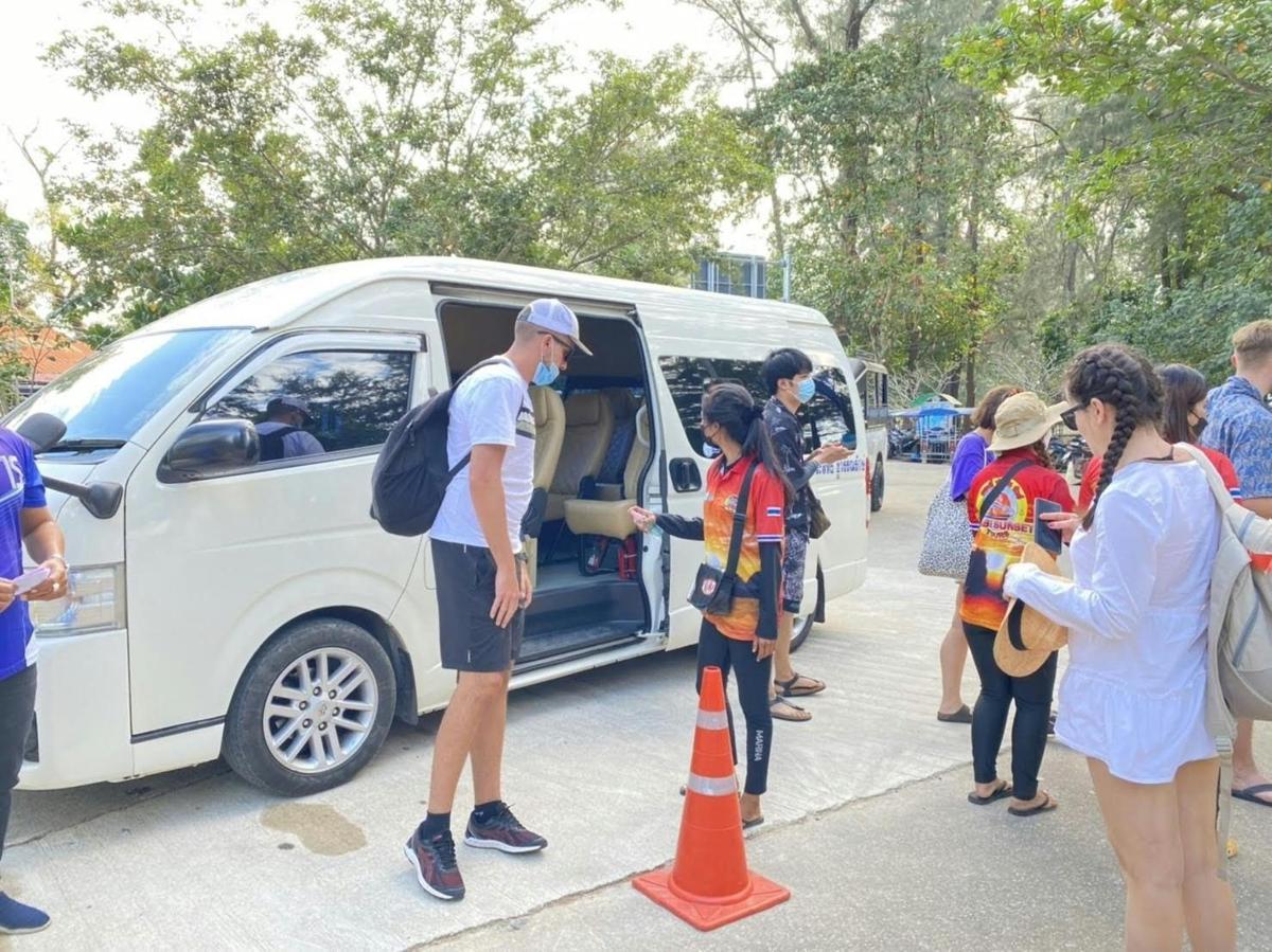 a group of people standing around a white van