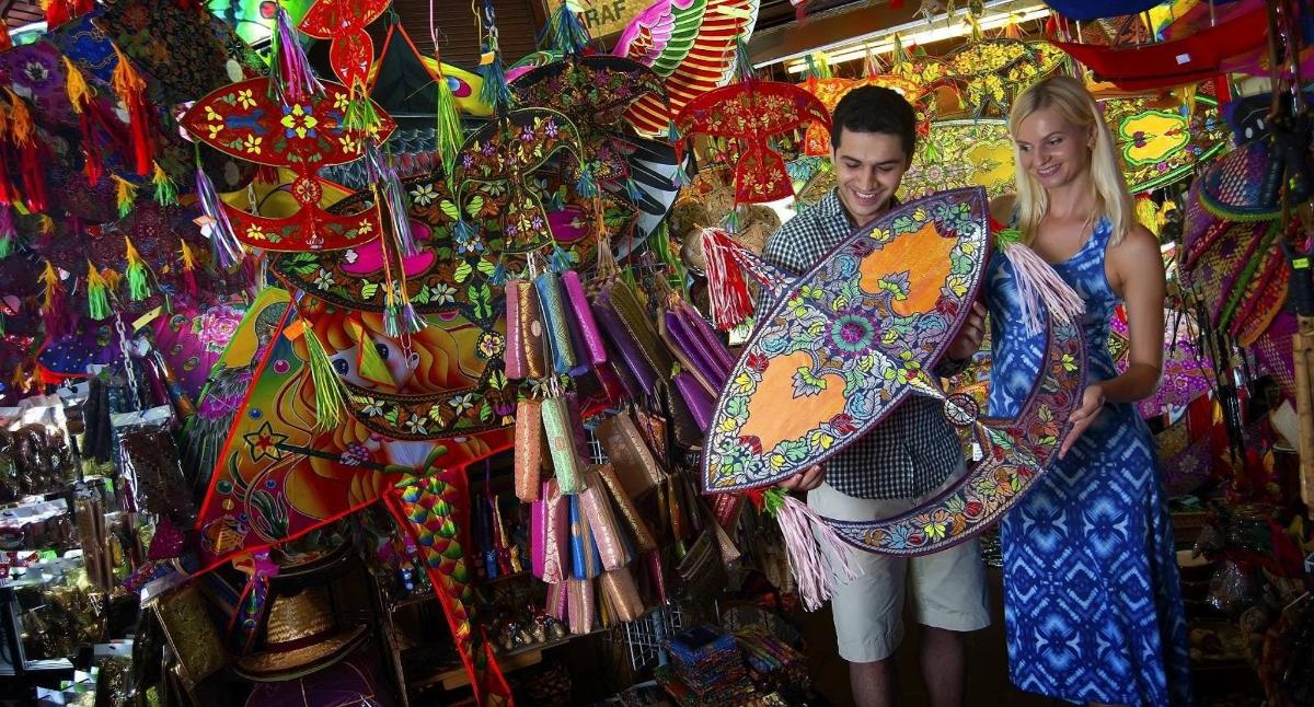 a man and woman standing in a store with umbrellas