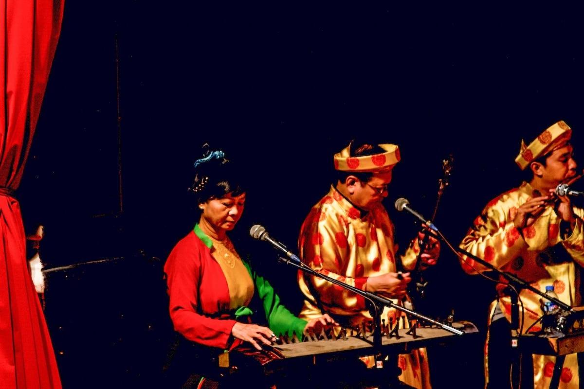 a group of people in costumes playing a musical instrument