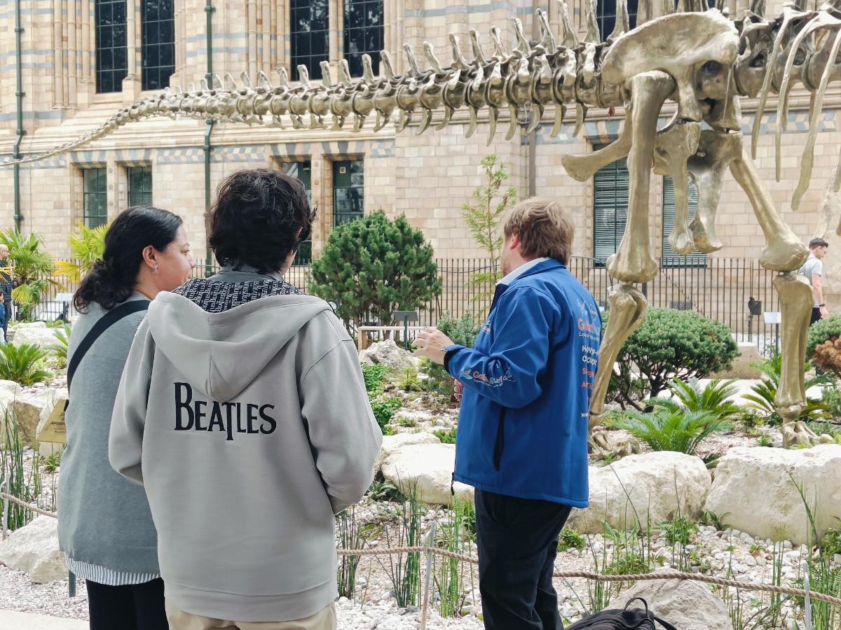 a group of people standing next to a statue