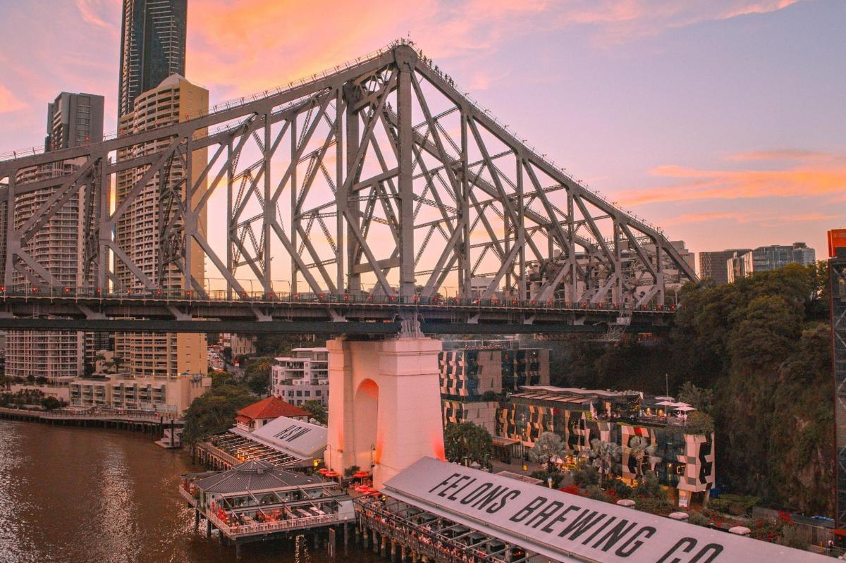 a large bridge over a river with a city