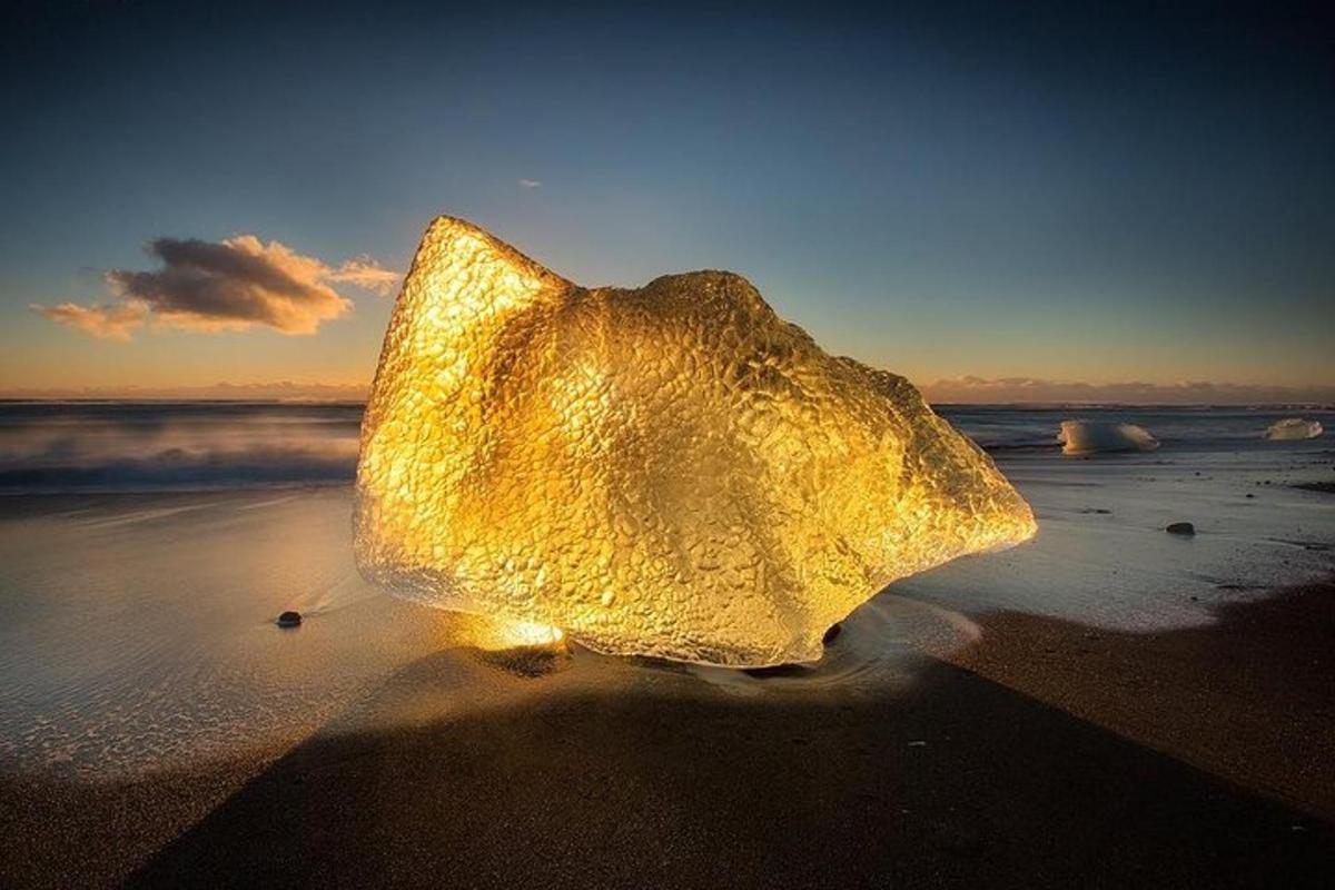 un grande oggetto di vetro appoggiato sulla spiaggia