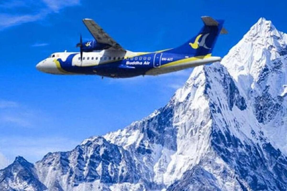a plane flying over a snow covered mountain