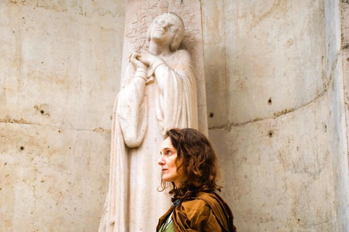 a woman standing in front of a statue