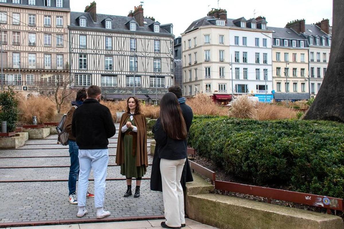 a group of people walking down a sidewalk in a city