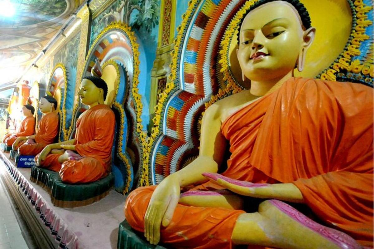 a group of statues of monks sitting in a room