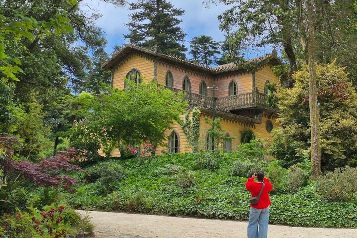 a woman taking a picture of a house