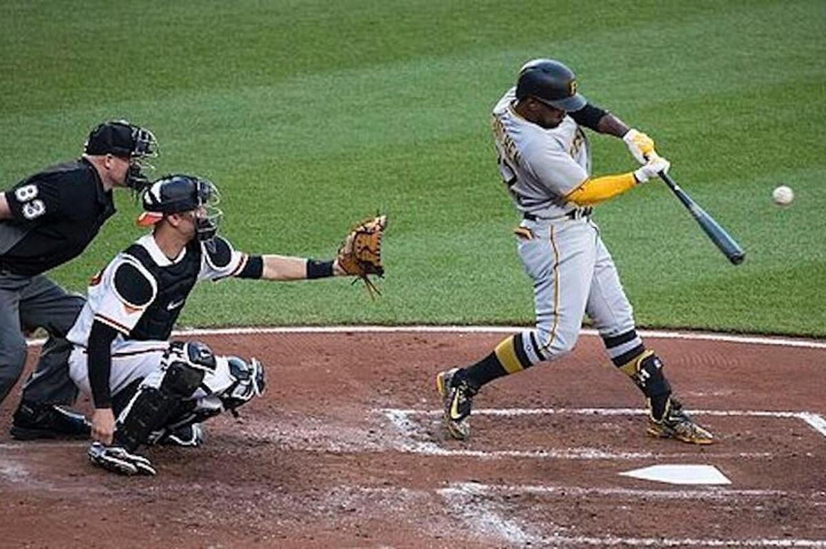 a baseball player swinging a bat at a ball
