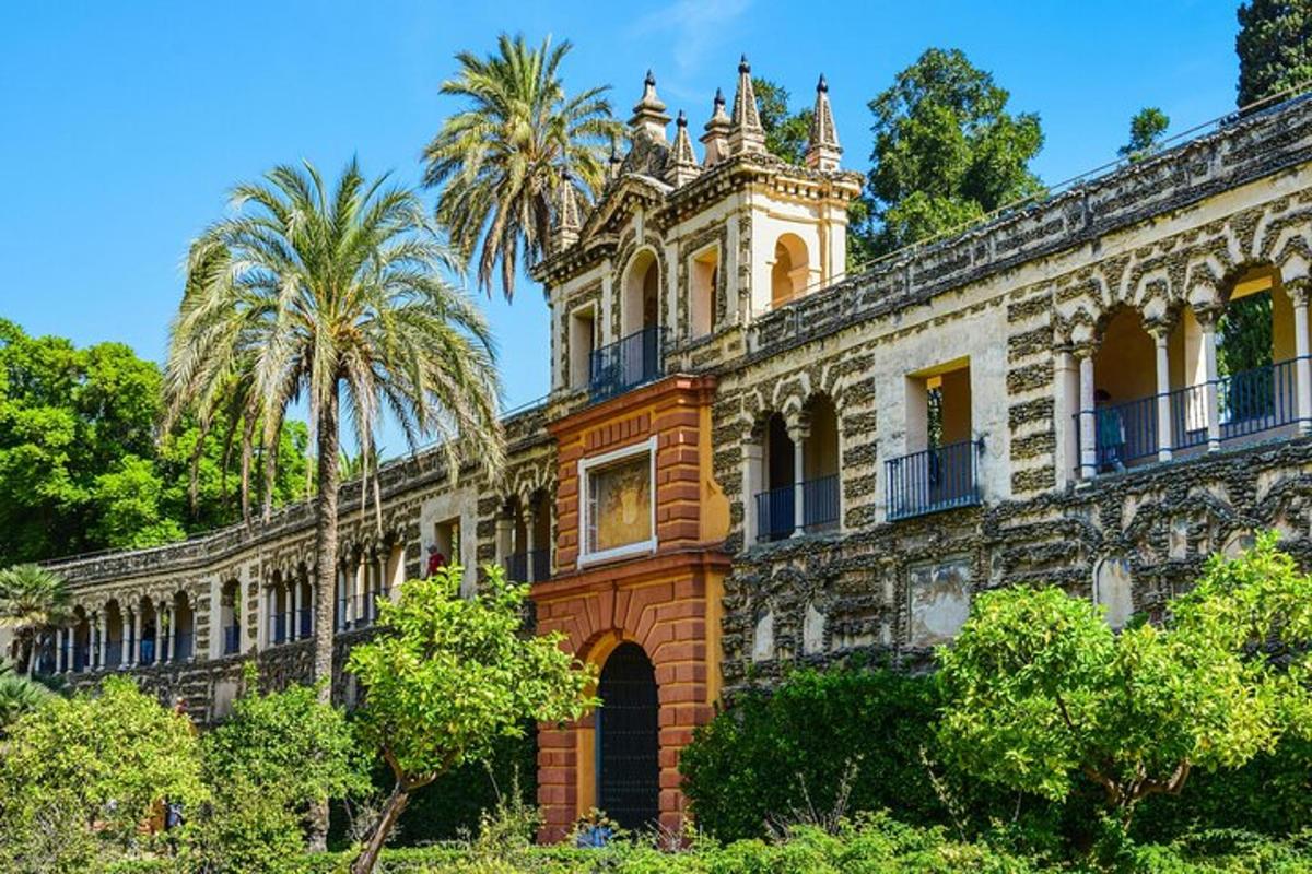 an old building with a tower and palm trees