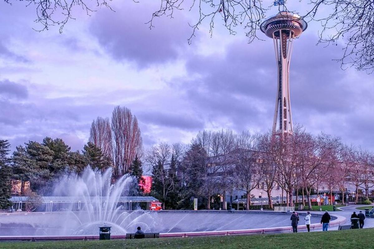 a water fountain and a tower in a park