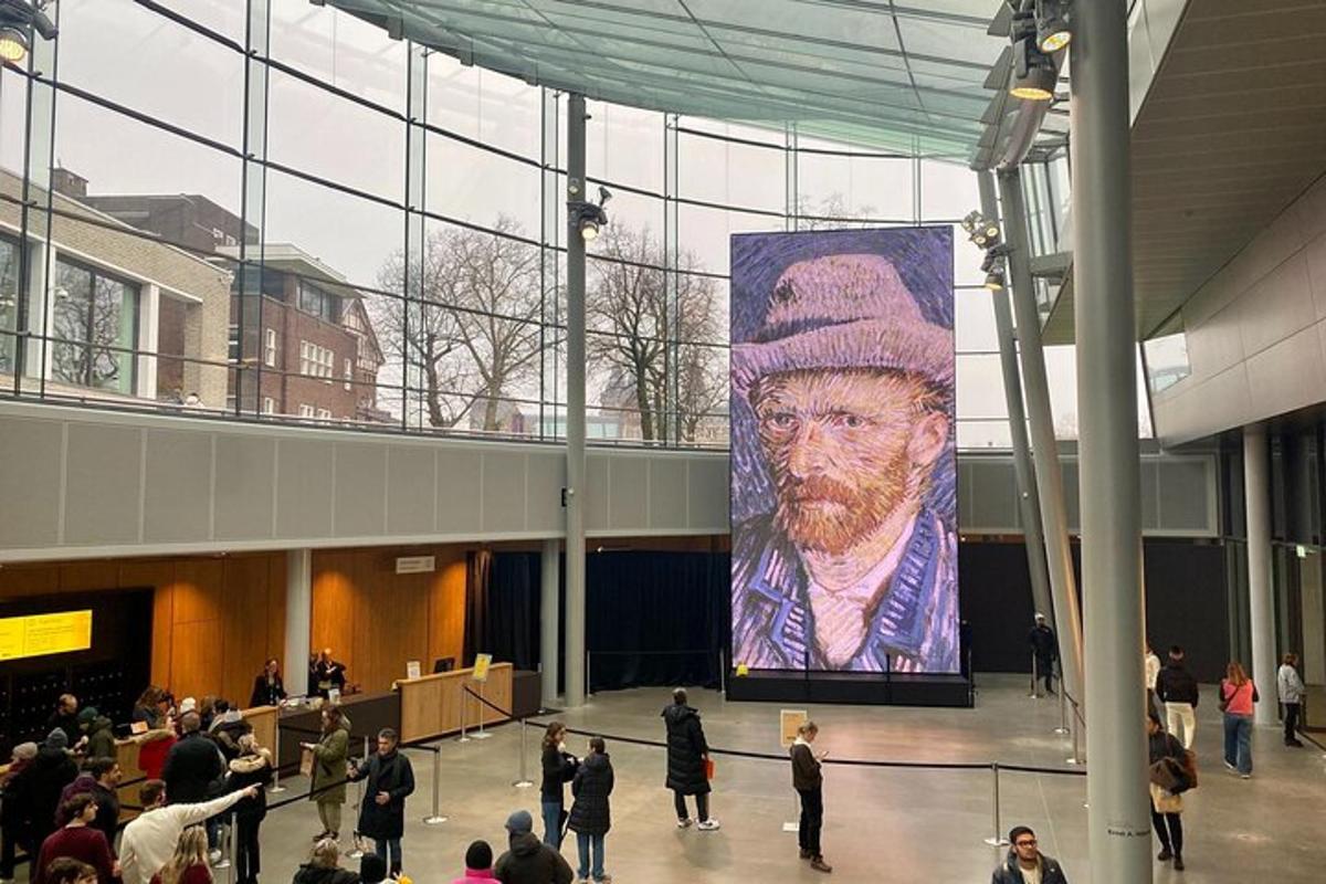 a large painting of a man in a hat in a building