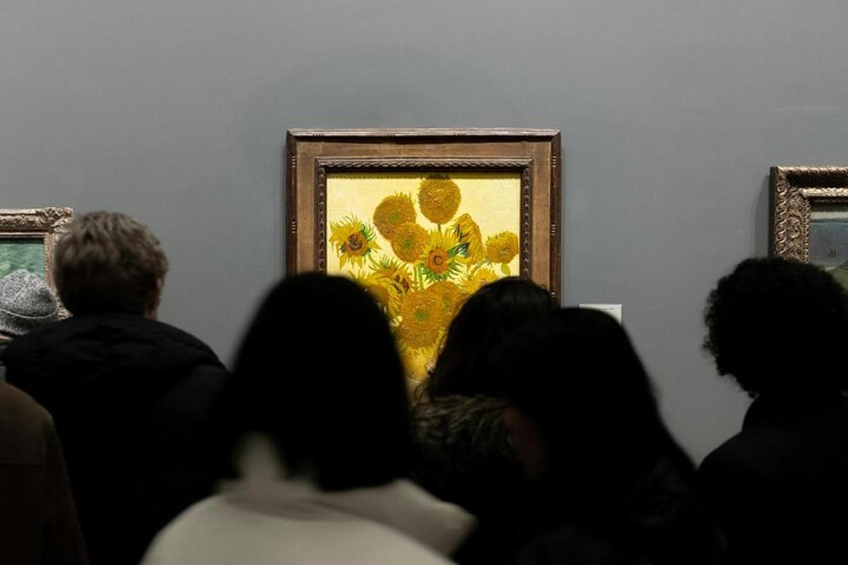 a group of people sitting in front of a painting